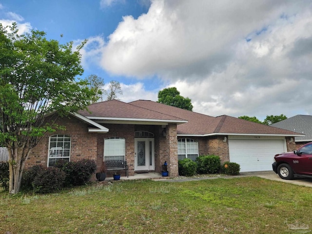 single story home featuring an attached garage, concrete driveway, brick siding, and a front yard