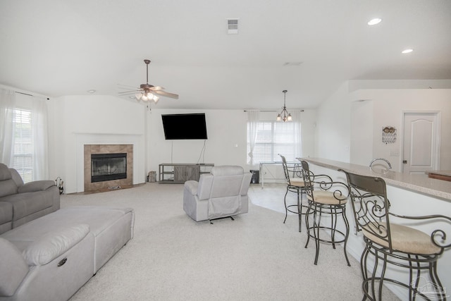 living area with ceiling fan, light colored carpet, visible vents, a tile fireplace, and recessed lighting
