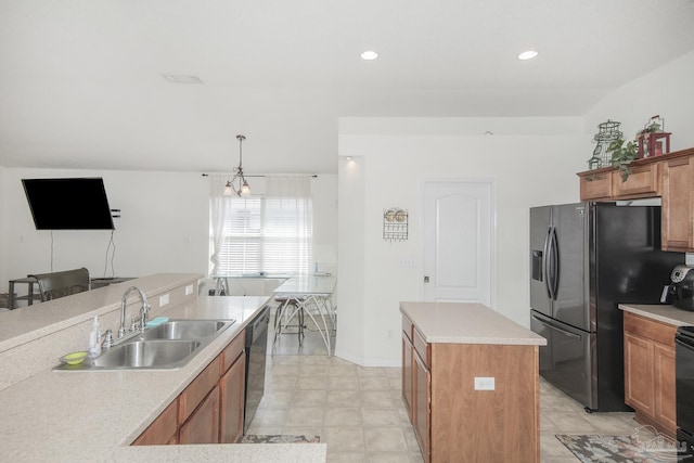 kitchen with brown cabinetry, a center island, light countertops, a sink, and black appliances
