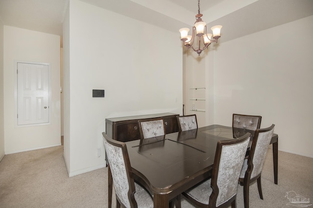 dining area featuring light colored carpet, baseboards, and a notable chandelier