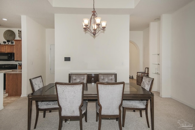 dining room with recessed lighting, arched walkways, a chandelier, and light carpet