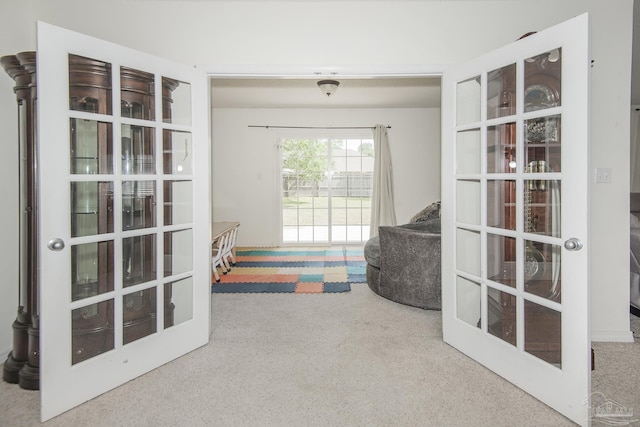 sitting room featuring french doors and carpet flooring