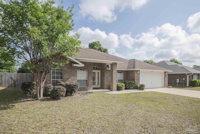 ranch-style house featuring fence, an attached garage, brick siding, a front yard, and concrete driveway
