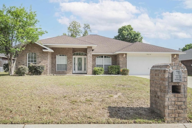 ranch-style house featuring a shingled roof, an attached garage, brick siding, a front yard, and driveway