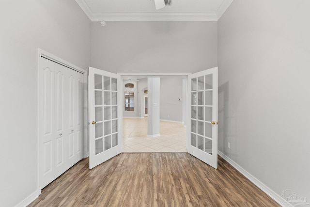 entrance foyer with french doors, crown molding, and wood-type flooring