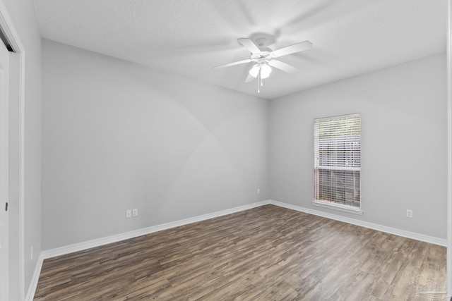 unfurnished room with a textured ceiling, dark hardwood / wood-style flooring, and ceiling fan