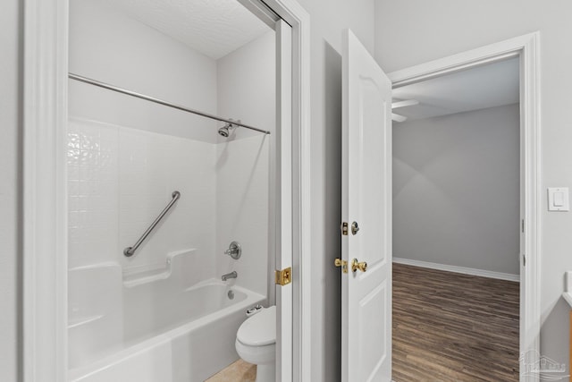 bathroom with shower / tub combination, wood-type flooring, and toilet