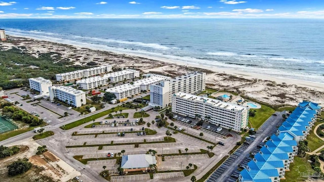 drone / aerial view featuring a water view and a view of the beach