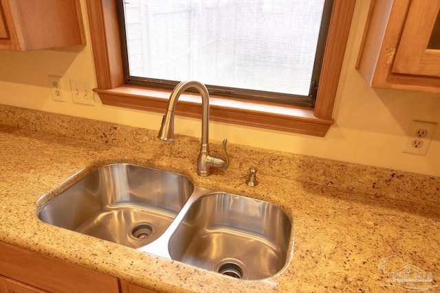 details featuring sink and light stone counters