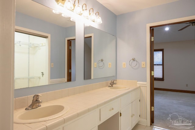 bathroom featuring ceiling fan and vanity