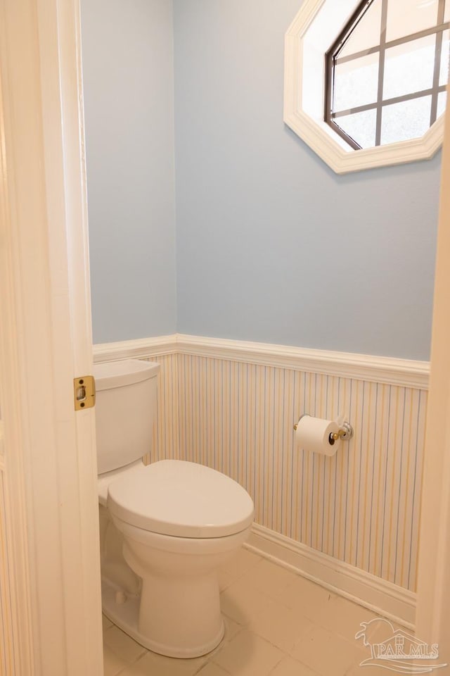 bathroom with toilet and tile patterned flooring