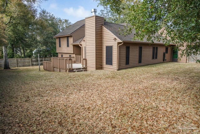 back of house featuring a yard and a deck