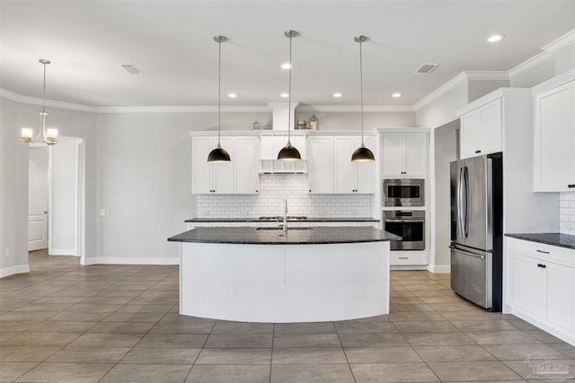 5936 Huntington Creek Blvd, Pensacola, FL 32526 - kitchen featuring stainless steel appliances, backsplash, ornamental molding, white cabinets, and a center island with sink