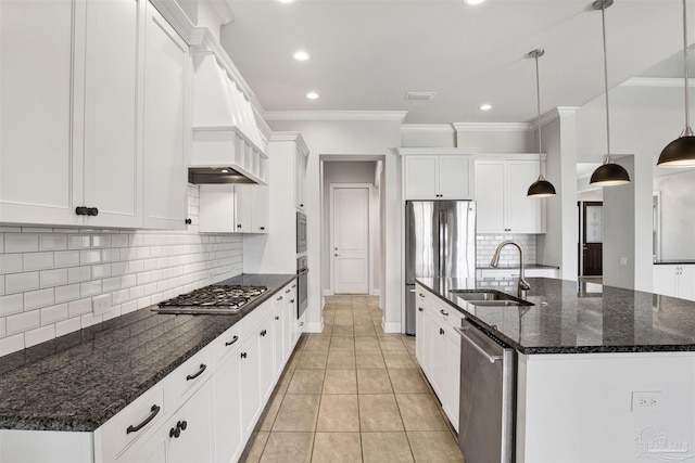 5936 Huntington Creek Blvd, Pensacola, FL 32526 - kitchen with appliances with stainless steel finishes, crown molding, a center island with sink, white cabinets, and recessed lighting