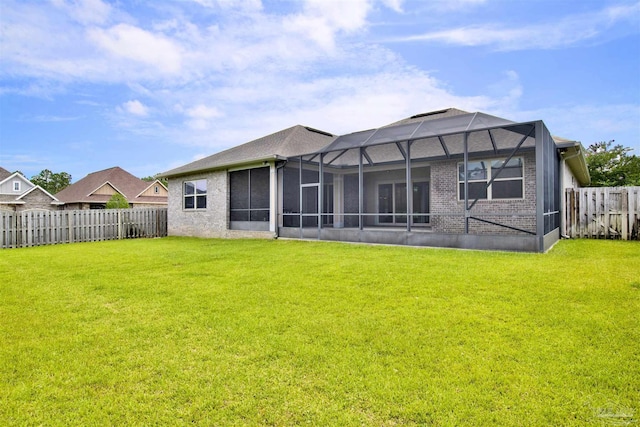5936 Huntington Creek Blvd, Pensacola, FL 32526 - back of property featuring a fenced backyard, brick siding, and glass enclosure
