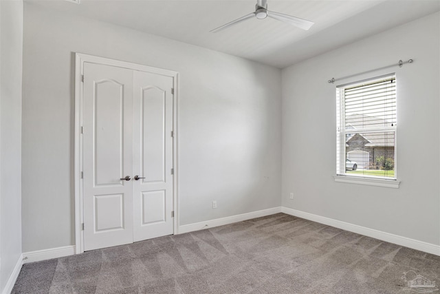 5936 Huntington Creek Blvd, Pensacola, FL 32526 - unfurnished bedroom featuring carpet floors, multiple windows, a closet, and a ceiling fan