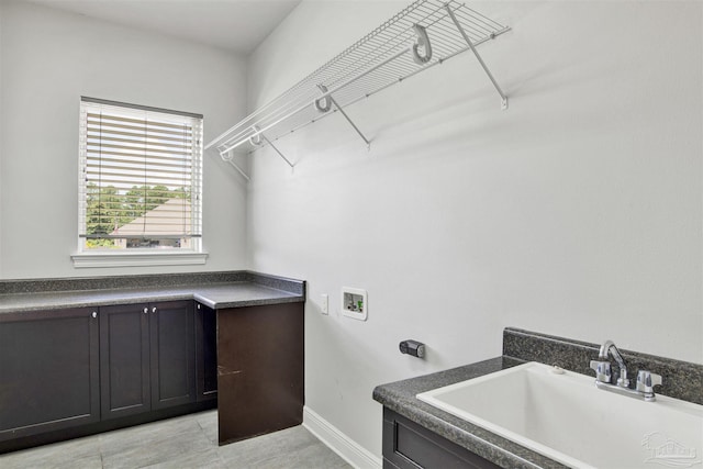 5936 Huntington Creek Blvd, Pensacola, FL 32526 - laundry room with washer hookup, cabinet space, and light tile patterned floors