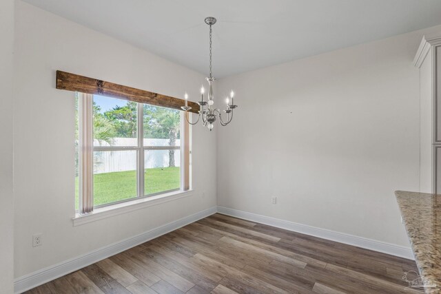2006 Costa Verde Ct, Navarre, FL 32566 - unfurnished dining area with a chandelier, baseboards, and wood finished floors