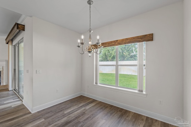 2006 Costa Verde Ct, Navarre, FL 32566 - unfurnished dining area featuring wood finished floors, a chandelier, and baseboards