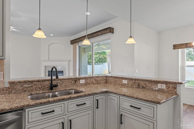 2006 Costa Verde Ct, Navarre, FL 32566 - kitchen with a sink, stainless steel dishwasher, stone countertops, ornamental molding, and wood finished floors