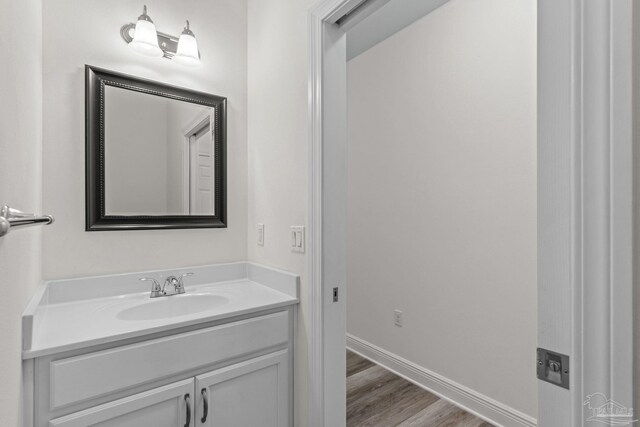 2006 Costa Verde Ct, Navarre, FL 32566 - bathroom with vanity, wood finished floors, and baseboards