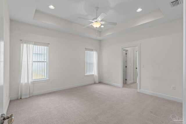 2006 Costa Verde Ct, Navarre, FL 32566 - spare room featuring a tray ceiling, light carpet, ceiling fan, baseboards, and recessed lighting