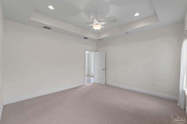 2006 Costa Verde Ct, Navarre, FL 32566 - spare room featuring a tray ceiling, light colored carpet, baseboards, ceiling fan, and recessed lighting