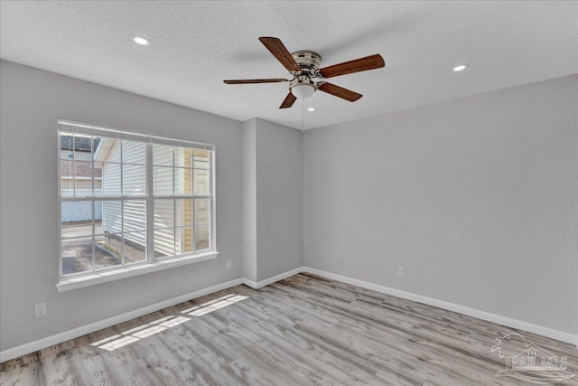 601 E Burgess Rd Unit J2, Pensacola, FL 32504 - spare room featuring a ceiling fan, wood finished floors, baseboards, recessed lighting, and a textured ceiling