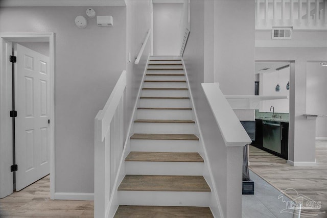 601 E Burgess Rd Unit J2, Pensacola, FL 32504 - stairway featuring wood finished floors and baseboards