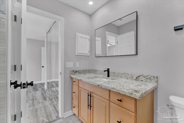 601 E Burgess Rd Unit J2, Pensacola, FL 32504 - bathroom with vanity, toilet, and baseboards