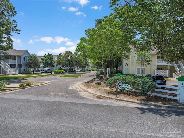 601 E Burgess Rd Unit J2, Pensacola, FL 32504 - view of asphalt road with curbs, stairs, a residential view, sidewalks, and traffic signs