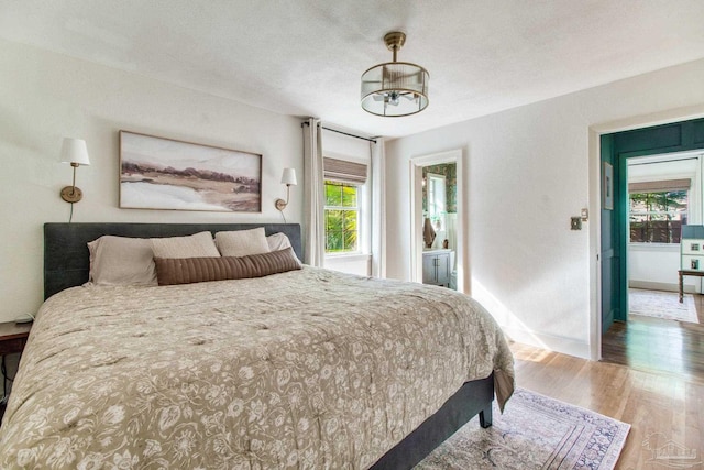 bedroom with a textured ceiling and wood finished floors