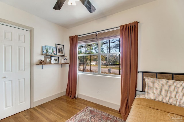 interior space featuring baseboards, wood finished floors, and a ceiling fan