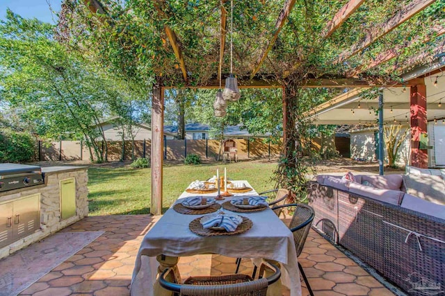 view of patio with area for grilling, outdoor dining space, and a fenced backyard