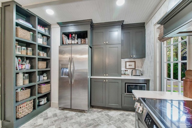 kitchen with brick floor, stainless steel appliances, open shelves, and gray cabinets