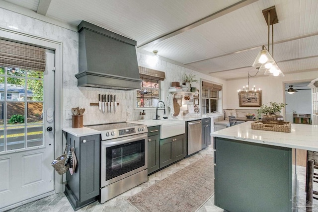 kitchen featuring a sink, a kitchen island, stainless steel appliances, light stone countertops, and custom exhaust hood