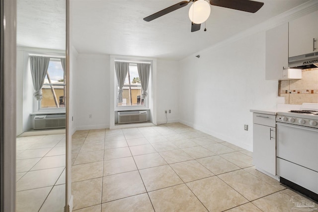 kitchen with light tile patterned floors, white range oven, a wall mounted AC, and crown molding