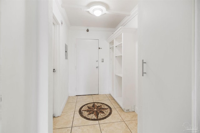 hall with light tile patterned floors and ornamental molding