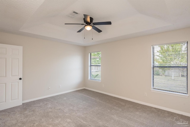 10104 Clearsound Dr, Pensacola, FL 32506 - empty room featuring a raised ceiling, carpet, visible vents, and ceiling fan