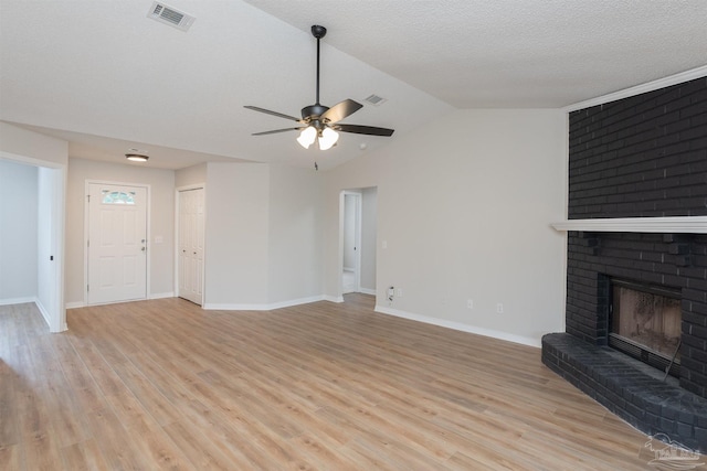 10104 Clearsound Dr, Pensacola, FL 32506 - unfurnished living room with vaulted ceiling, ceiling fan, a fireplace, baseboards, and visible vents