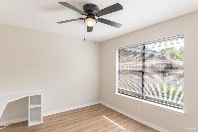10104 Clearsound Dr, Pensacola, FL 32506 - empty room with baseboards, a ceiling fan, a textured ceiling, and light wood-style flooring