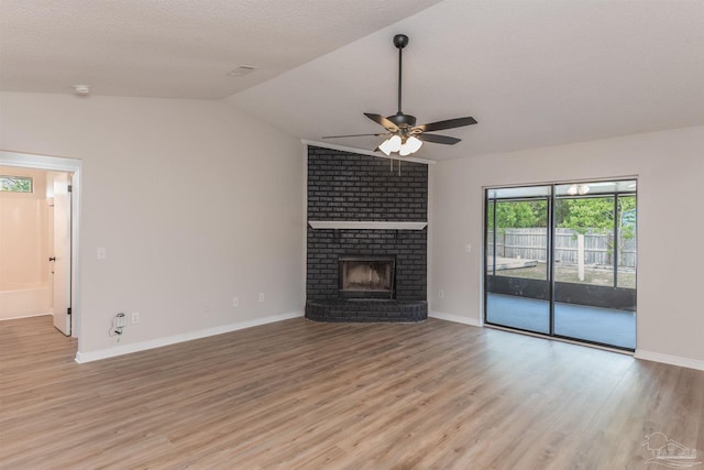 10104 Clearsound Dr, Pensacola, FL 32506 - unfurnished living room featuring light wood finished floors, baseboards, lofted ceiling, a ceiling fan, and a fireplace