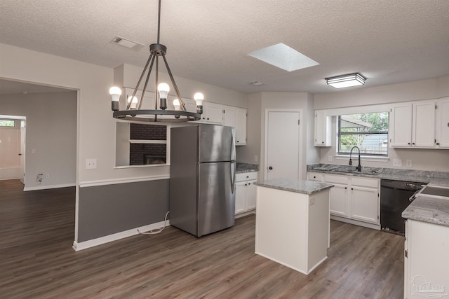 10104 Clearsound Dr, Pensacola, FL 32506 - kitchen featuring dark wood finished floors, white cabinets, visible vents, and freestanding refrigerator