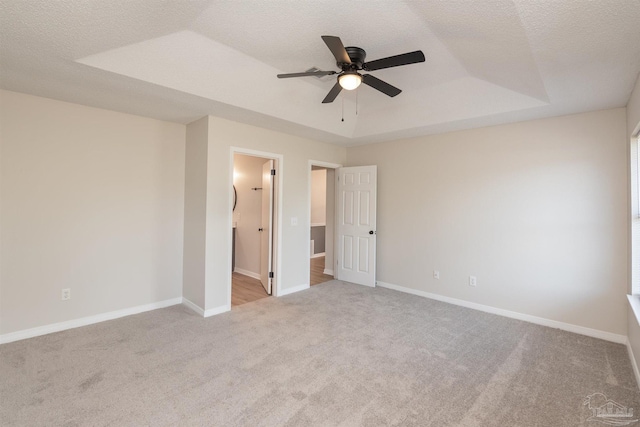 10104 Clearsound Dr, Pensacola, FL 32506 - unfurnished bedroom with baseboards, carpet flooring, a tray ceiling, and a textured ceiling