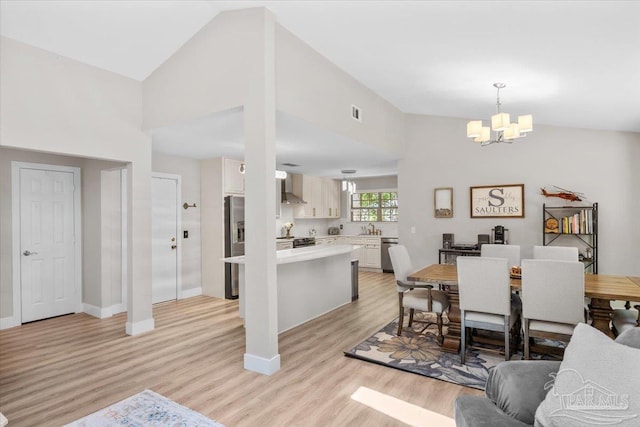 4308 Northpointe Way, Pensacola, FL 32514 - dining area featuring a chandelier, light wood finished floors, baseboards, and a high ceiling
