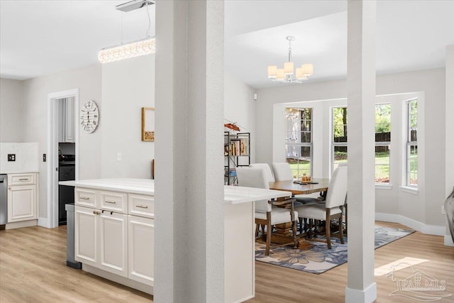 4308 Northpointe Way, Pensacola, FL 32514 - kitchen featuring light wood-type flooring, a chandelier, light countertops, white cabinetry, and dishwasher