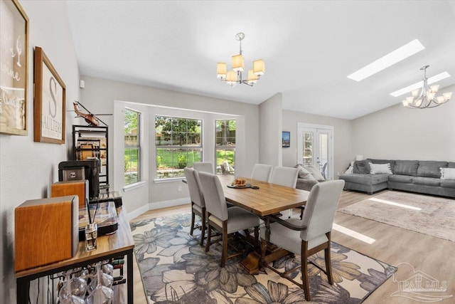 4308 Northpointe Way, Pensacola, FL 32514 - dining space with a chandelier, wood finished floors, a skylight, and vaulted ceiling