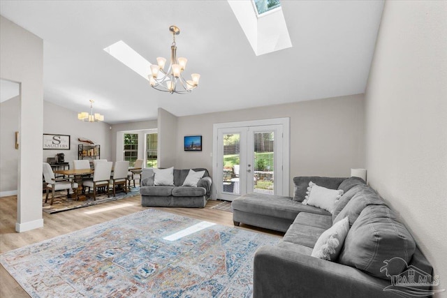 4308 Northpointe Way, Pensacola, FL 32514 - living room with a chandelier, a skylight, vaulted ceiling, wood finished floors, and french doors