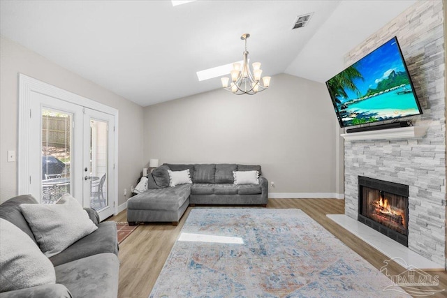 4308 Northpointe Way, Pensacola, FL 32514 - living area with wood finished floors, lofted ceiling, baseboards, a stone fireplace, and a chandelier