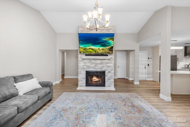 4308 Northpointe Way, Pensacola, FL 32514 - living area featuring baseboards, a chandelier, wood finished floors, vaulted ceiling, and a fireplace